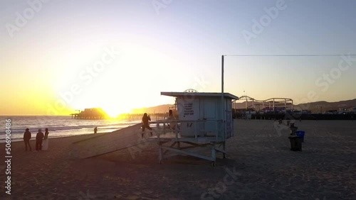 Sunset Photo shooting on lifeguard tower.
Spectacular aerial view flight pull in drone footage
at LA Santa Monica Pier California USA 2018. Cinematic view from above Tourist Guide by Philipp Marnitz