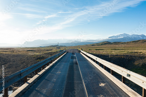 Road  bridge in Iceland. Snow in mountains in background. 