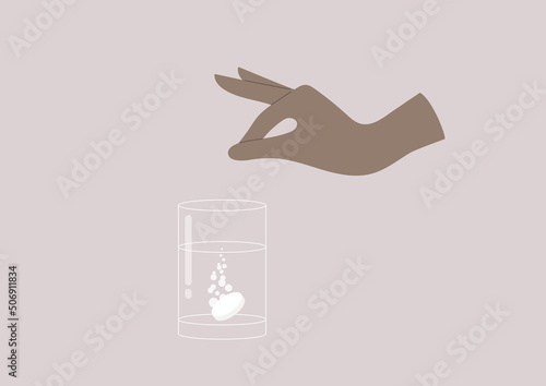 A pain killer pill dissolved in a glass of water, a medicine concept