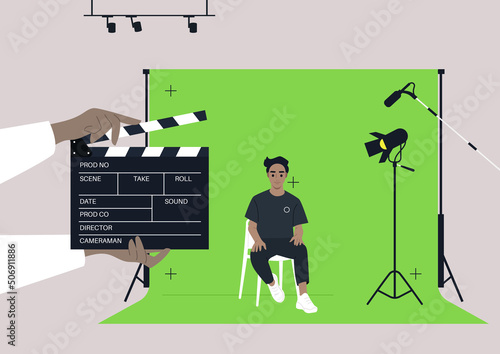 A chroma key screen in a movie studio, A young male Caucasian character sitting on a chair, a confident handsome actor being filmed in a video