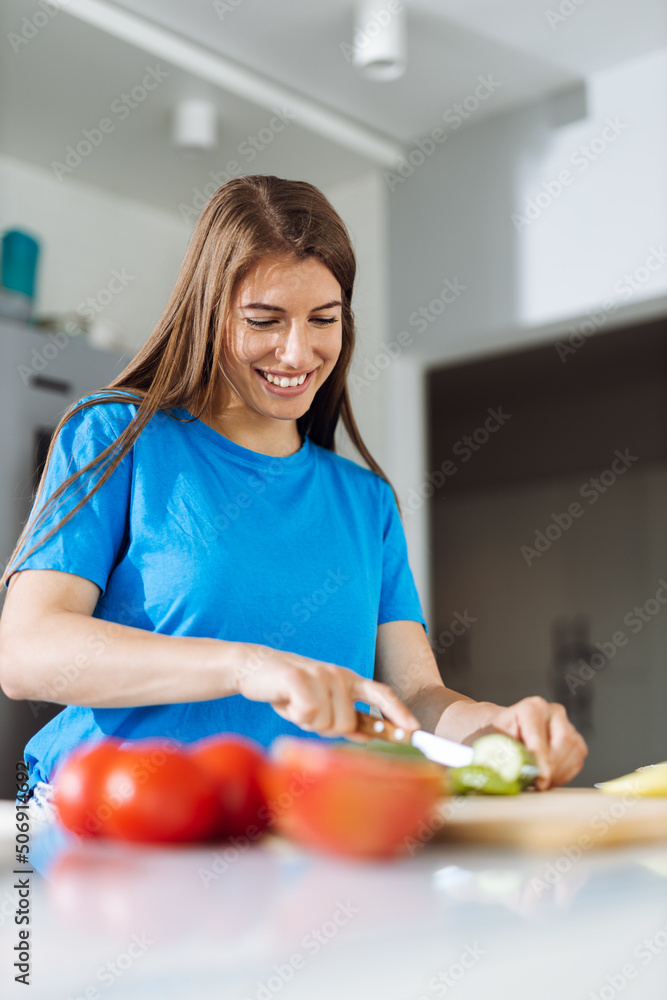 Young woman preparing salad in the kitchen Young woman preparing salad in the kitchen