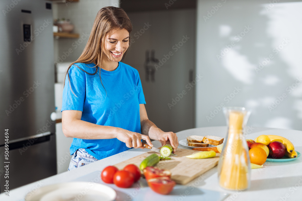 Young woman preparing salad in the kitchen Young woman preparing salad in the kitchen