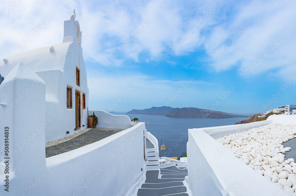 Fototapeta premium Oia town on Santorini island, Greece. Traditional and famous houses and churches with blue domes over the Caldera, Aegean sea