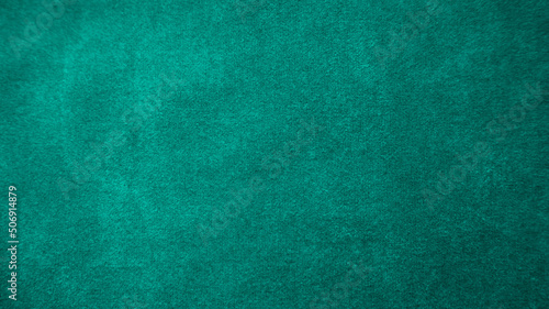 Dark green old velvet fabric texture used as background. Empty green fabric background of soft and smooth textile material. There is space for text....