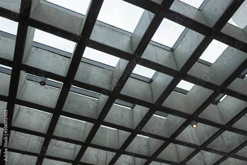 Modern interior, grid ceiling, cloudy sky