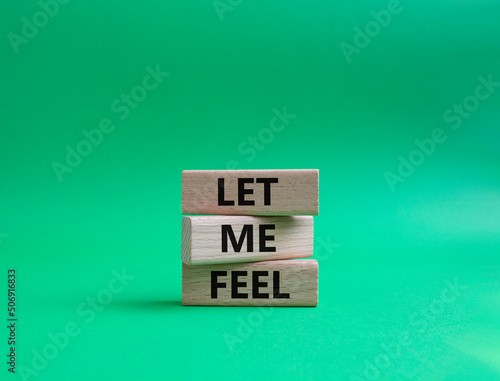 Feel symbol. Wooden blocks with words 'Let me feel'. Beautiful green background. Psychology and let me feel concept. Copy space.