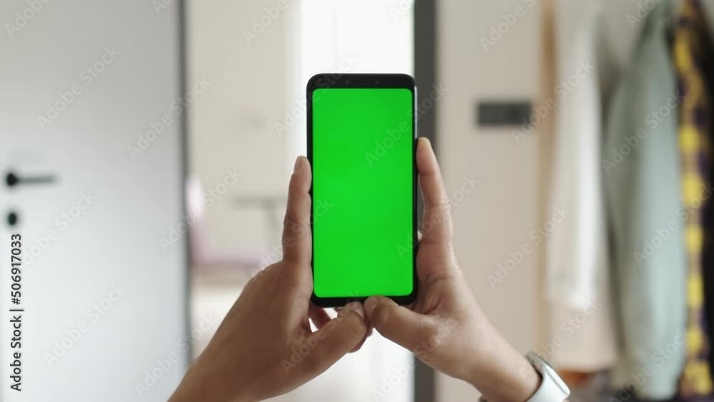 Handheld Slow Motion Camera: Point of View of Female at Cozy Room Using Phone With Green Mock-up Screen Chroma Key Surfing Internet, Watching Content Videos Blogs. POV View. Handheld Slow Motion Camera: Point of View of Female at Cozy Room Using Phone With Green Mock-up Screen Chroma Key Surfing Internet, Watching Content Videos Blogs. POV View.