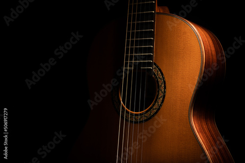 Classical guitar on a black background with copy space
