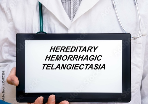Hereditary Hemorrhagic Telangiectasia.  Doctor with rare or orphan disease text on tablet screen Hereditary Hemorrhagic Telangiectasia photo