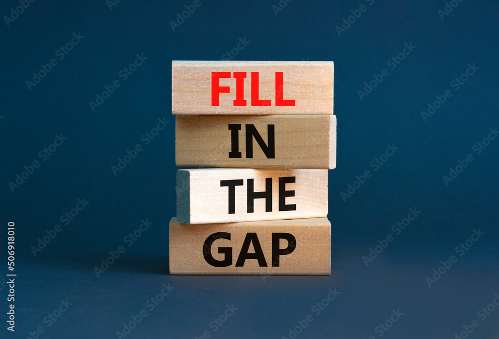 Fill in the gap symbol. Concept words Fill in the gap on wooden blocks on a beautiful grey table grey background. Business, motivational and fill in the gap concept. Fill in the gap symbol. Concept words Fill in the gap on wooden blocks on a beautiful grey table grey background. Business, motivational and fill in the gap concept.