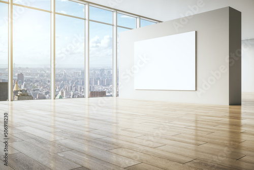 Big blank white poster on beige partition in empty spacious hall with wooden floor and city view from huge window. 3D rendering  mockup