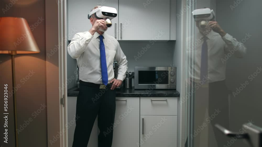 Senior executive in vr goggles drink coffee in office kitchen Senior executive in vr goggles drink coffee in office kitchen