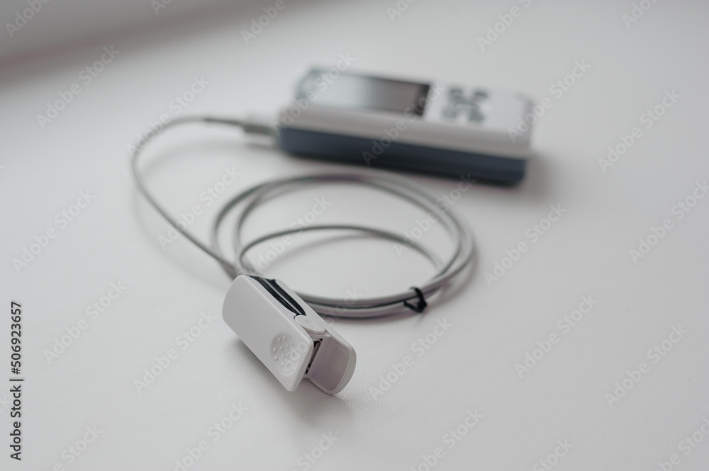 Pulse oximeter on a white background. Medical control and diagnostic device for measuring the saturation of capillary blood with oxygen Pulse oximeter on a white background. Medical control and diagnostic device for measuring the saturation of capillary blood with oxygen