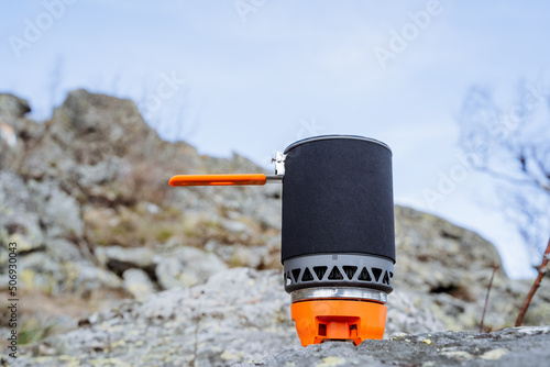 Tourist utensils for hiking in the mountains, equipment for mountaineering, gas portable burner, cooking in a hike in the mountains.