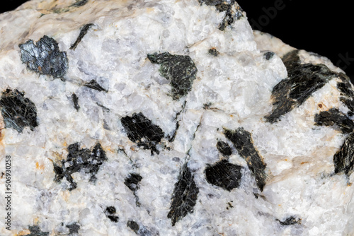 Pegmatite granite from central Arizona. Large black biotite mica crystals against white quartz. Photographed on black background.
 photo