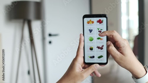 Wallpaper Mural Girl Lying on Couch in Apartment Using Smartphone and Ordering Fresh Fruits and Vegetables in Grocery Online Store Application for Home Delivery. Female Selects Natural Organic Food in Supermarket. Torontodigital.ca