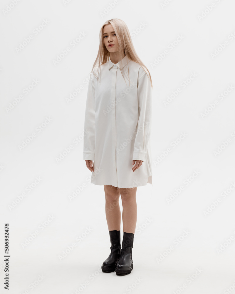 Studio photoshoot of a smiling young blond woman wearing casual clothing against a white background. Natural makeup and hairstyle Studio photoshoot of a smiling young blond woman wearing casual clothing against a white background. Natural makeup and hairstyle