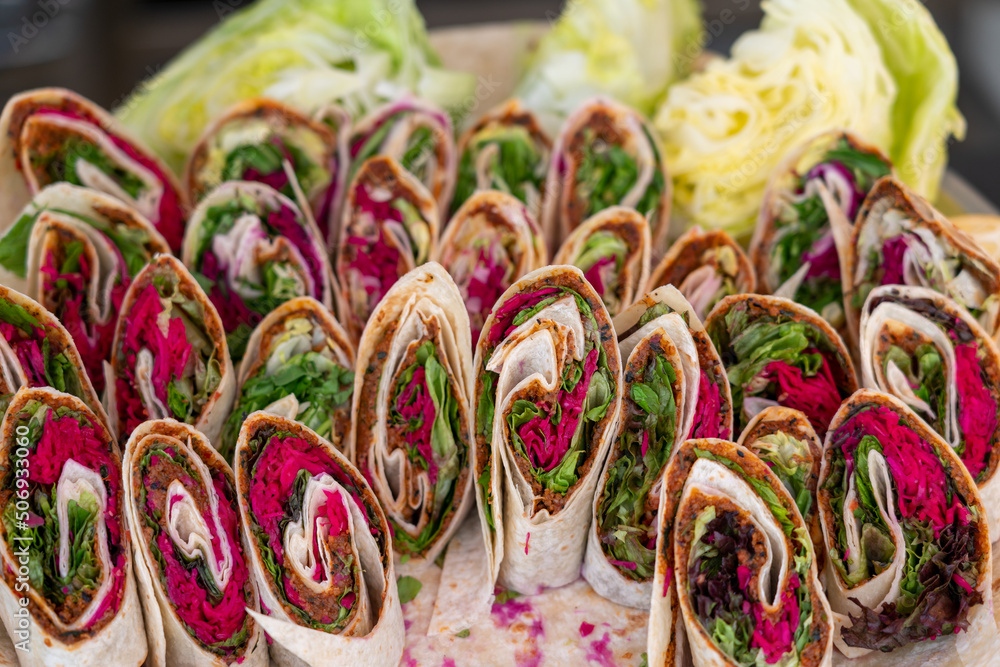 Wrap sandwich, many rolls with fresh vegetables on a plate