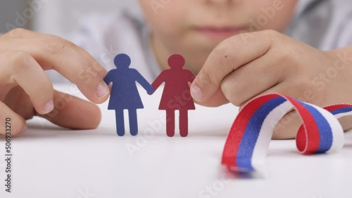 Paper women in the hands of a boy.