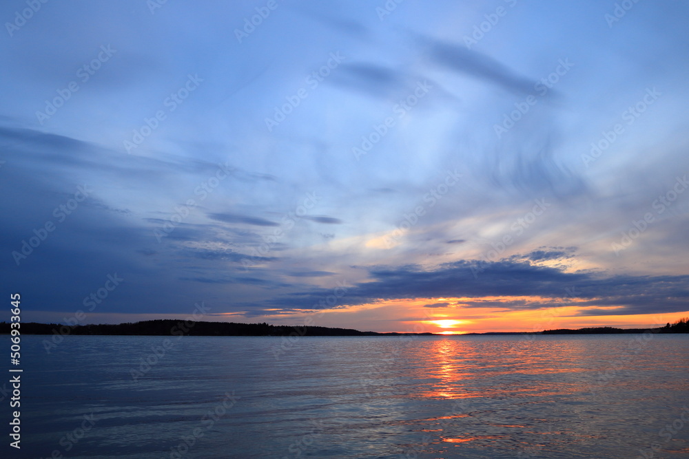 Gorgeous sunset at golden hour. Swedish nature or lake during spring. Relaxing vacation feeling. At Mälaren, Stockholm, Sweden, Scandinavia, Europe. Gorgeous sunset at golden hour. Swedish nature or lake during spring. Relaxing vacation feeling. At Mälaren, Stockholm, Sweden, Scandinavia, Europe.