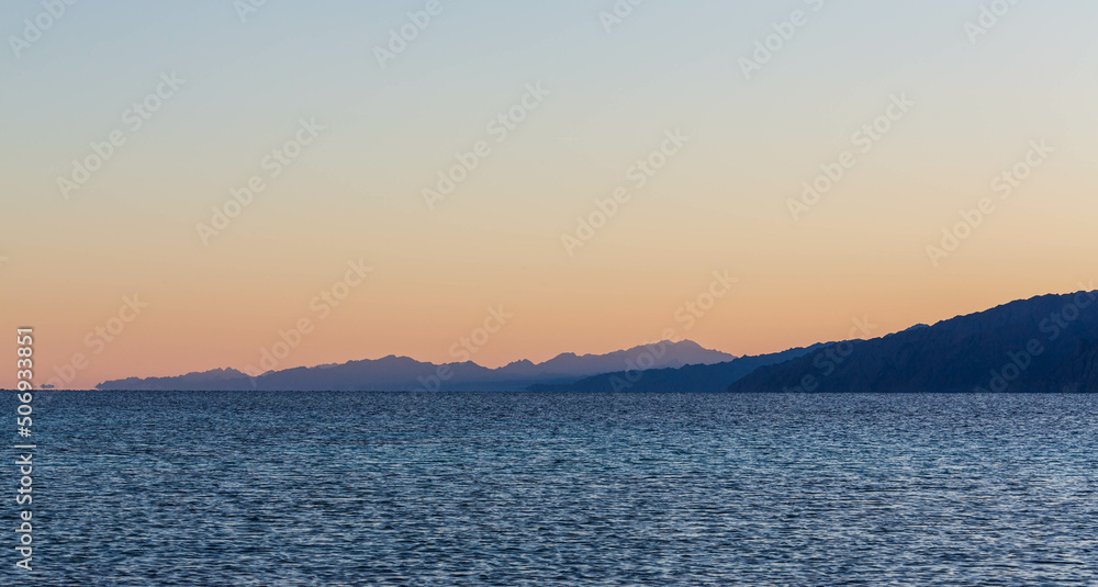 Beautiful sunset with orange sky in Lagoona beach, Dahab, Egypt