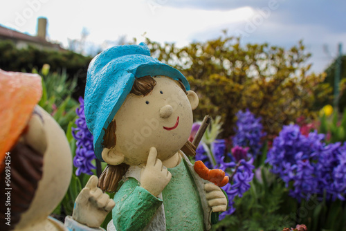 Smiling dwarf in colorful garden