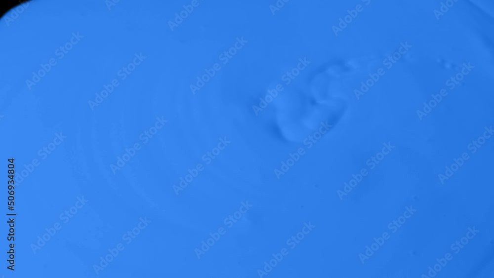 Blue Paint Poured Onto Black Surface Blue Paint Poured Onto Black Surface