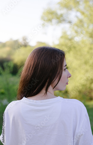 portrait of young woman from the back in profile view 