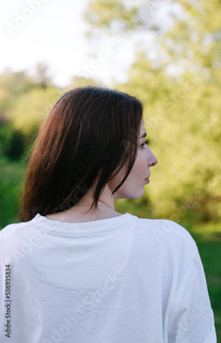 portrait of young woman from the back in profile view