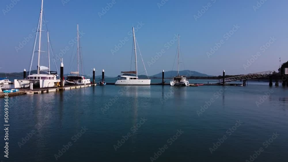Private sailing yacht stands in the marina, modern sailing catamaran in the dock Private sailing yacht stands in the marina, modern sailing catamaran in the dock