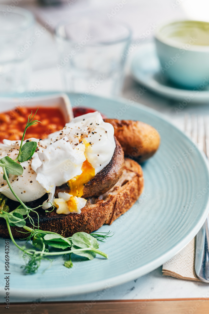 Healthy breakfast from poached eggs, grilled halloumi, Scrambled smoked harissa tofu, smashed avocado, grilled mushrooms and tomato beans on toast Healthy breakfast from poached eggs, grilled halloumi, Scrambled smoked harissa tofu, smashed avocado, grilled mushrooms and tomato beans on toast