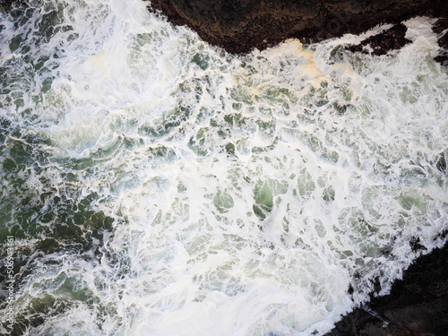 Shooting from a drone. Foamy ocean waves. Storm. Beauty of nature. Minimalism. Abstraction. There are no people in the photo. Ecology. Environment protection.