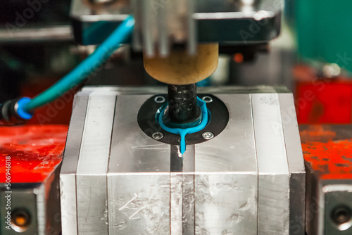 The process of blowing plastic tanks and canister in extrusion equipment. Molten white plastic like a tube is placed in a press form and blowing the air and is give to shape of the bottle