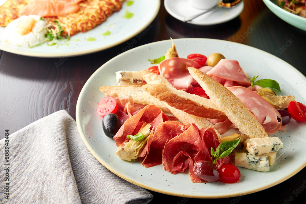 Platter with mortadella sausage, jamon and cheese.