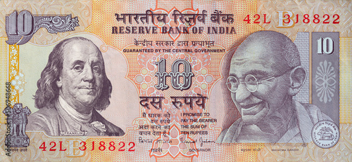 Foto old 10 Indian rupee obverse with superimposed Benjamin Franklin from 100 dollar