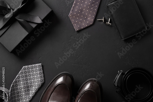 Classic mens accessories - gift, loafers shoes, tie ,belt on black background. Greeting card for Happy Father's Day.