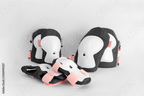 Top view of roller skates protective gear set - knee, elbow and wrist pads in pink colors. White grey background side view