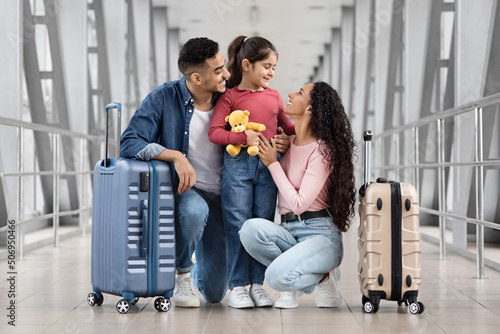 Happy Arab Family Of Three Bonding At Airport While Waiting For Flight