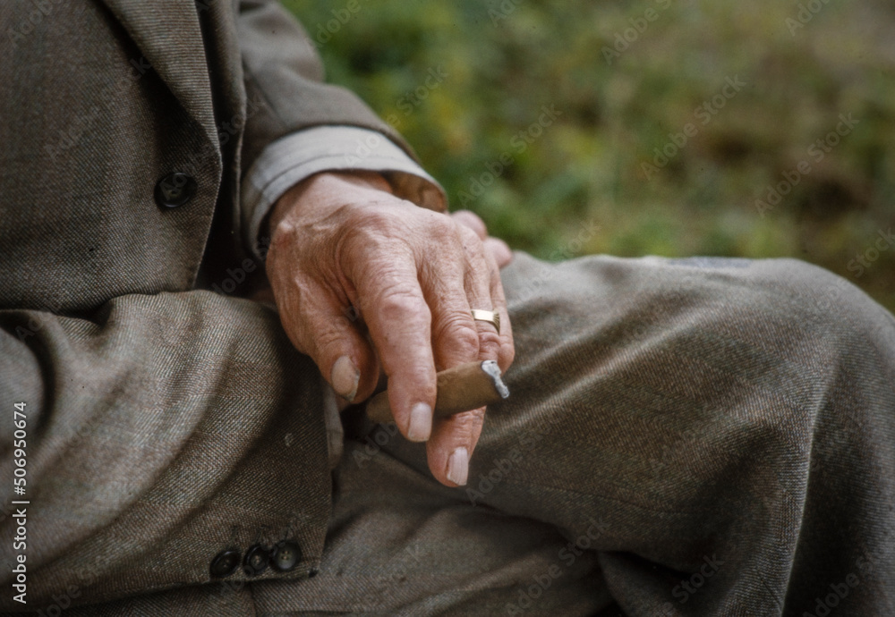 Hand of old man with sigar. Smoking a sigar. Retired man. Netherlands.