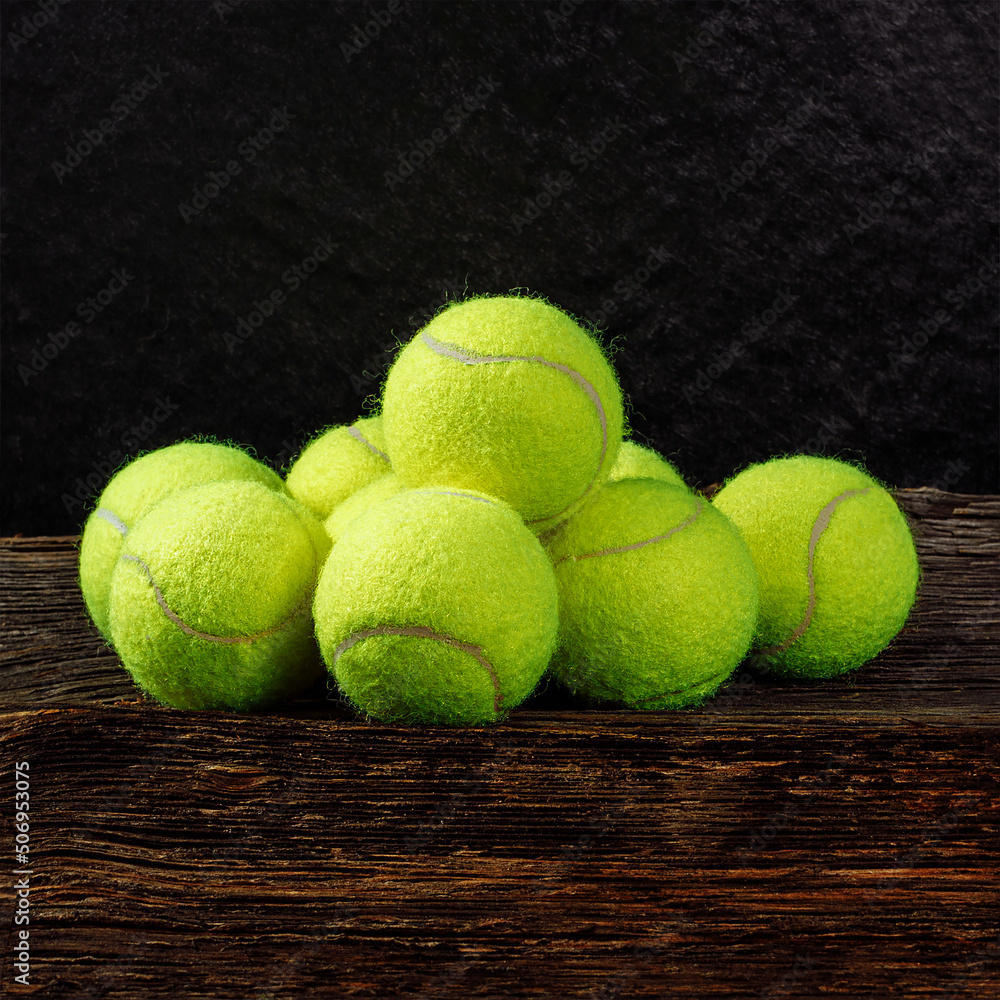 Yellow tennis balls on wooden background, space for text, sport and competition concept