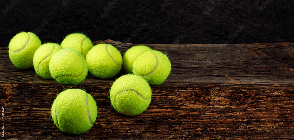 Tennis balls on wooden background, space for text, sport concept, rustic style, stock photo