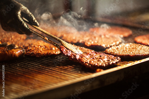 Chef Grilling Hamburgers on a Hot Plate