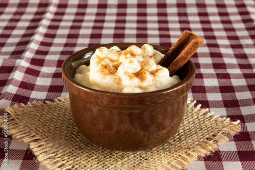 traditional sweet from the Brazilian June festivals, made of white corn with coconut and condensed milk and sprinkled with cinnamon photo