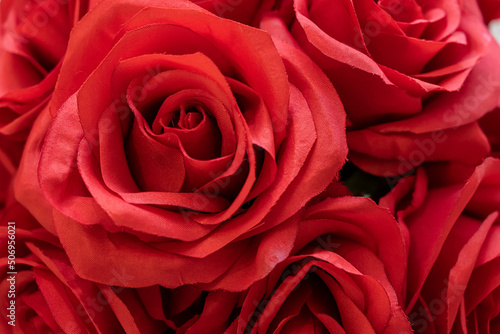 Close-up shot of an artificial flower bouquet of red roses