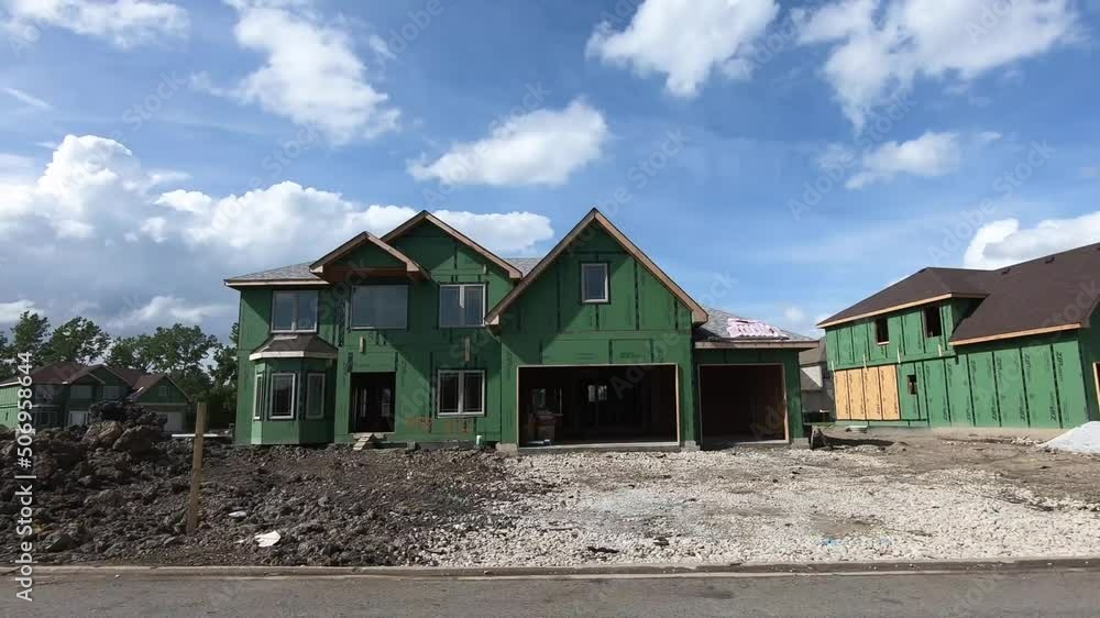 New home construction in suburban neighborhood on a sunny day. New home construction in suburban neighborhood on a sunny day.