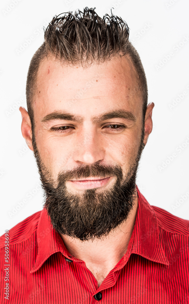 Fototapeta premium funny guy with a beard in a red shirt close-up shows different emotions. cheerful kind sad surprised satisfied range of emotions