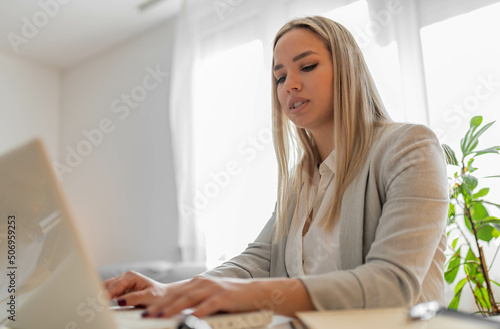 Business woman in office working on lap top