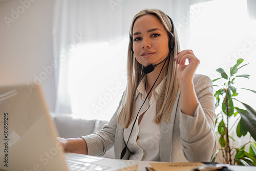 Young woman working in call center. Customer support woman in office