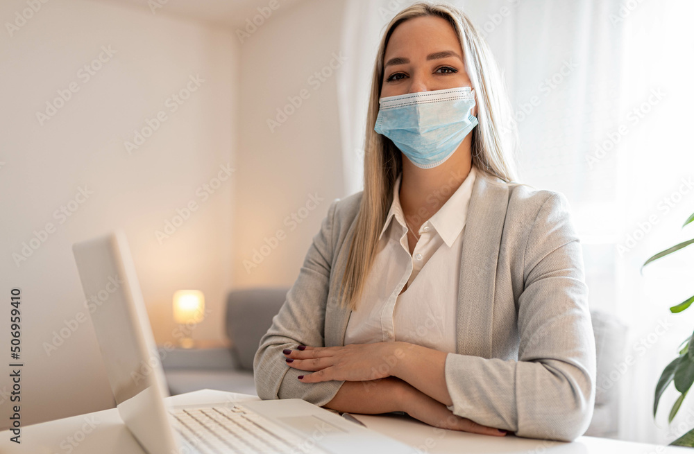 Pensive female entrepreneur with face mask working on business reports in the office. Copy space.
Pensive female entrepreneur with face mask working on business reports in the office. Copy space.