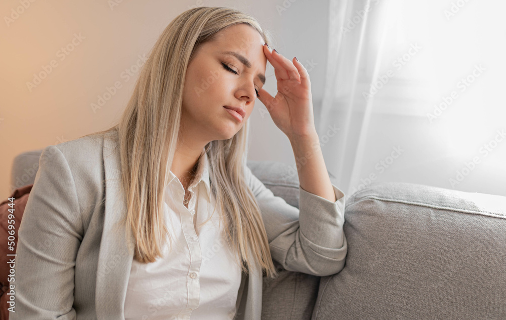 Portrait of tired young woman suffering from headache Portrait of tired young woman suffering from headache